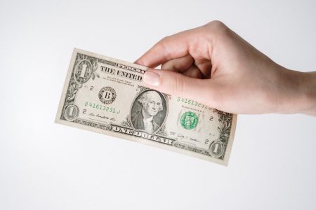 person holding a one dollar bill; Dollar-Cost Averaging, Does It Work?