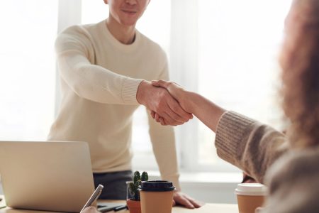 image with two people shaking hands about money