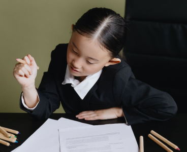 a young child in a ceo chair; How to Invest for Your Kids' Future