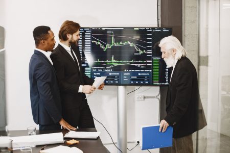 guys looking at a screen and what they made from a robo-advisor
