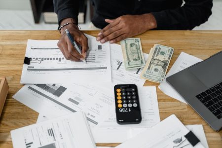 Business professional calculating taxes at desk; tax wrapper