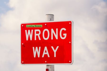 a large wrong way sign; investing the wrong way