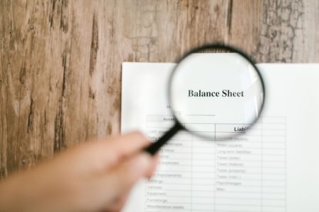 An eye glass looking at the words Balance Sheet