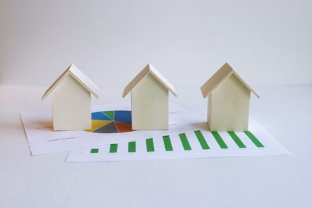 3 little houses and green lines showing growth;